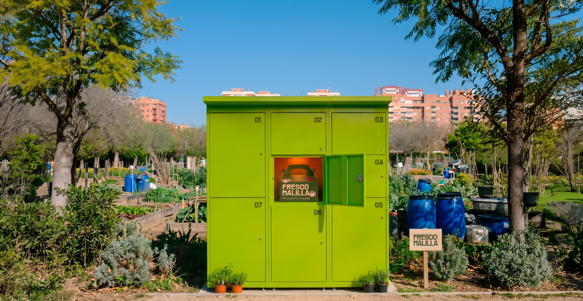 Lime-green Fresco Malilla collection lockers among the allotments of Malilla Urban Park.
