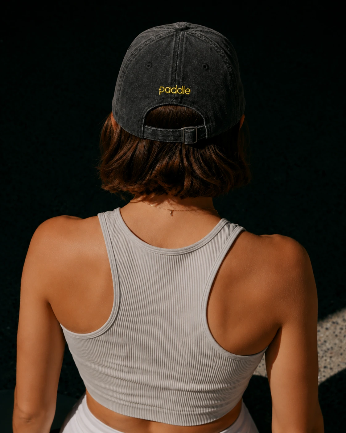 Rear view of a black cap embroidered with the Paddle wordmark.